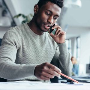 Advertising Executive on phone discussing advertising plan with client. 